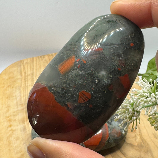 African bloodstone palm stone showing dark green chalcedony with red iron oxide flecks